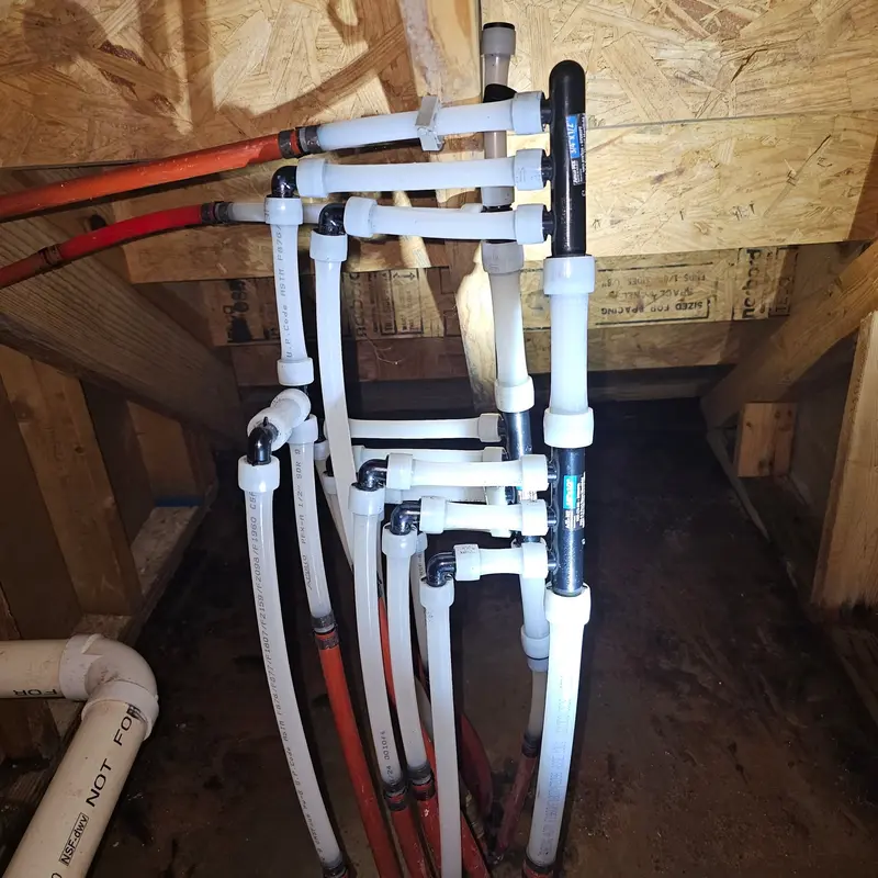 Freshly installed PEX plumbing manifold with organized pipe runs